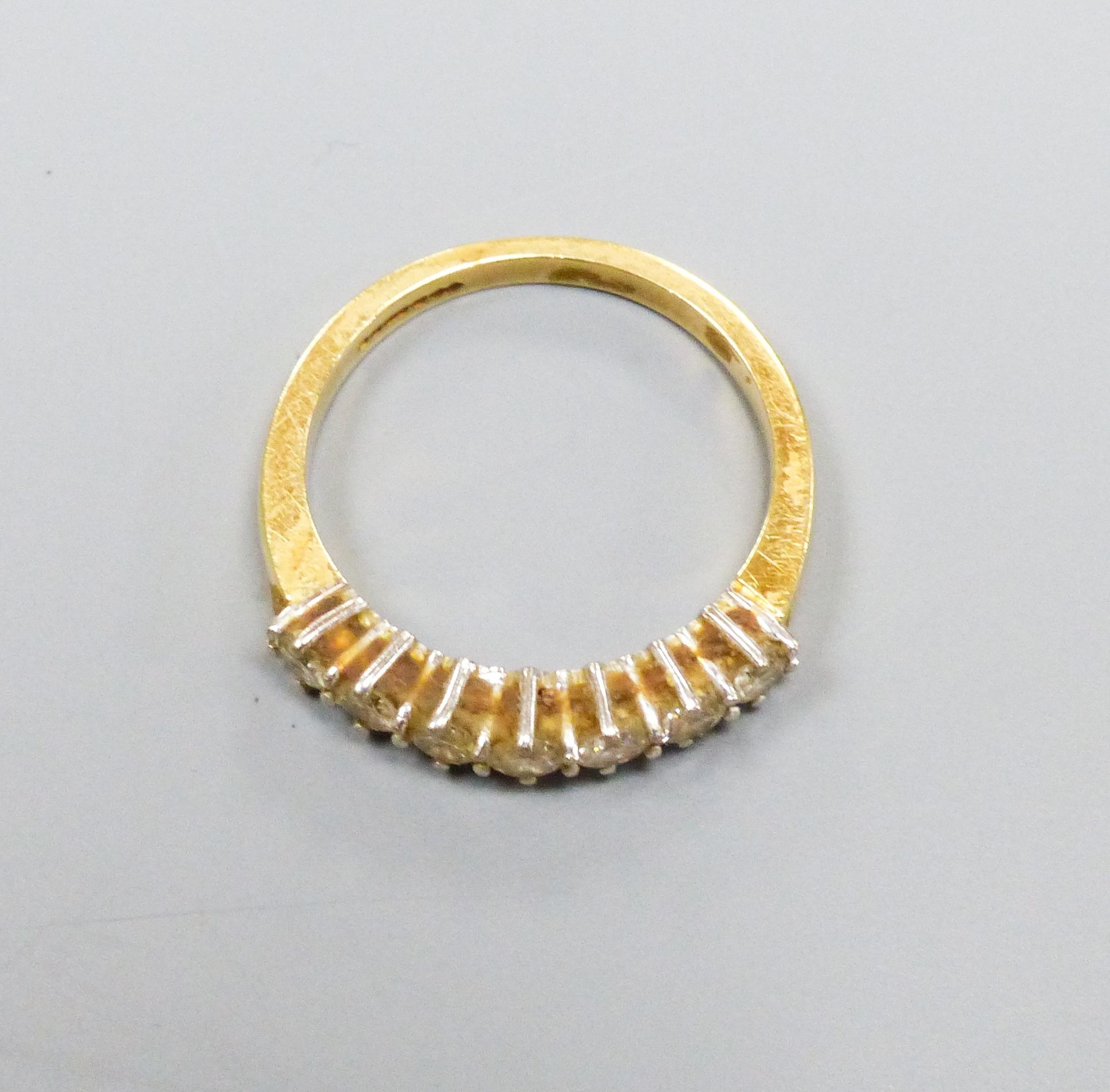 A modern 18ct gold and seven stone diamond set half hoop ring, size P/Q, gross weight 4.4 grams.